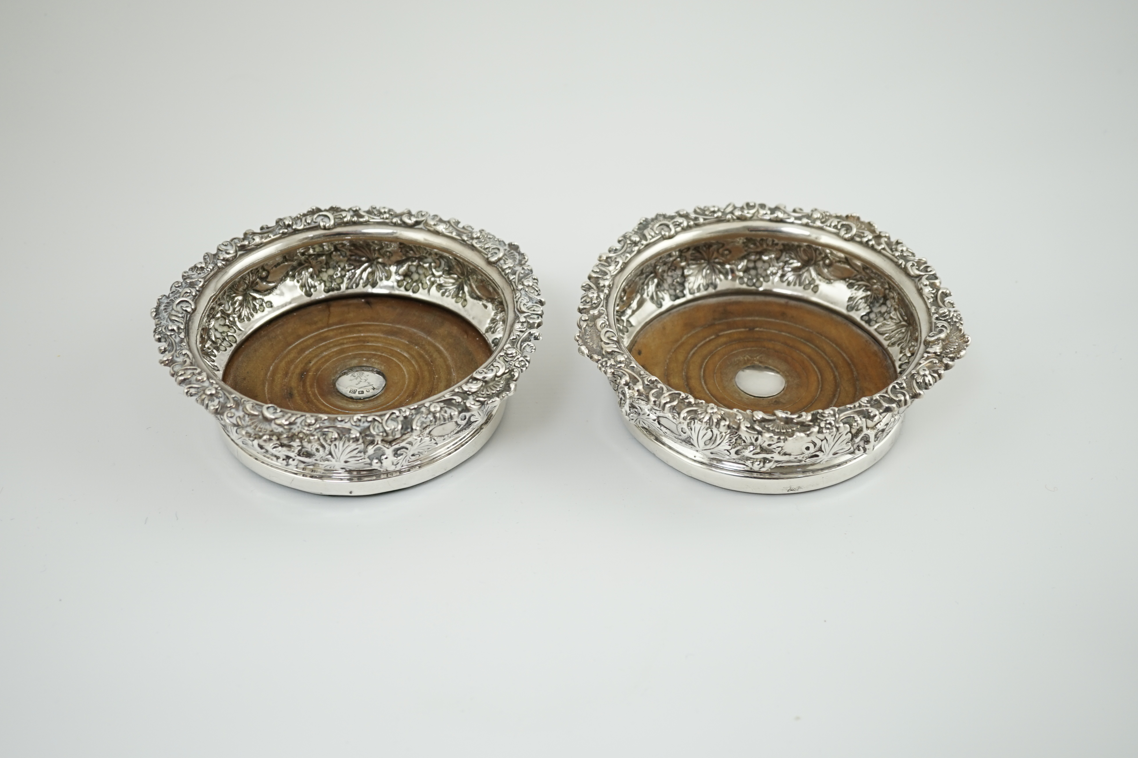 A pair of George IV silver wine coasters, by S.C. Younge & Co